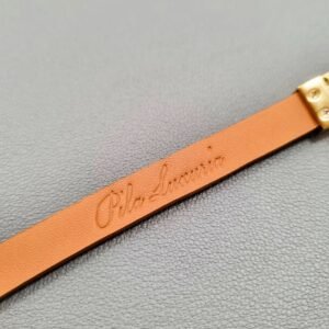 Embossed logo of a luxury green shark leather bracelet with a magnetic clasp, made by Pila Luxuria in Canada.