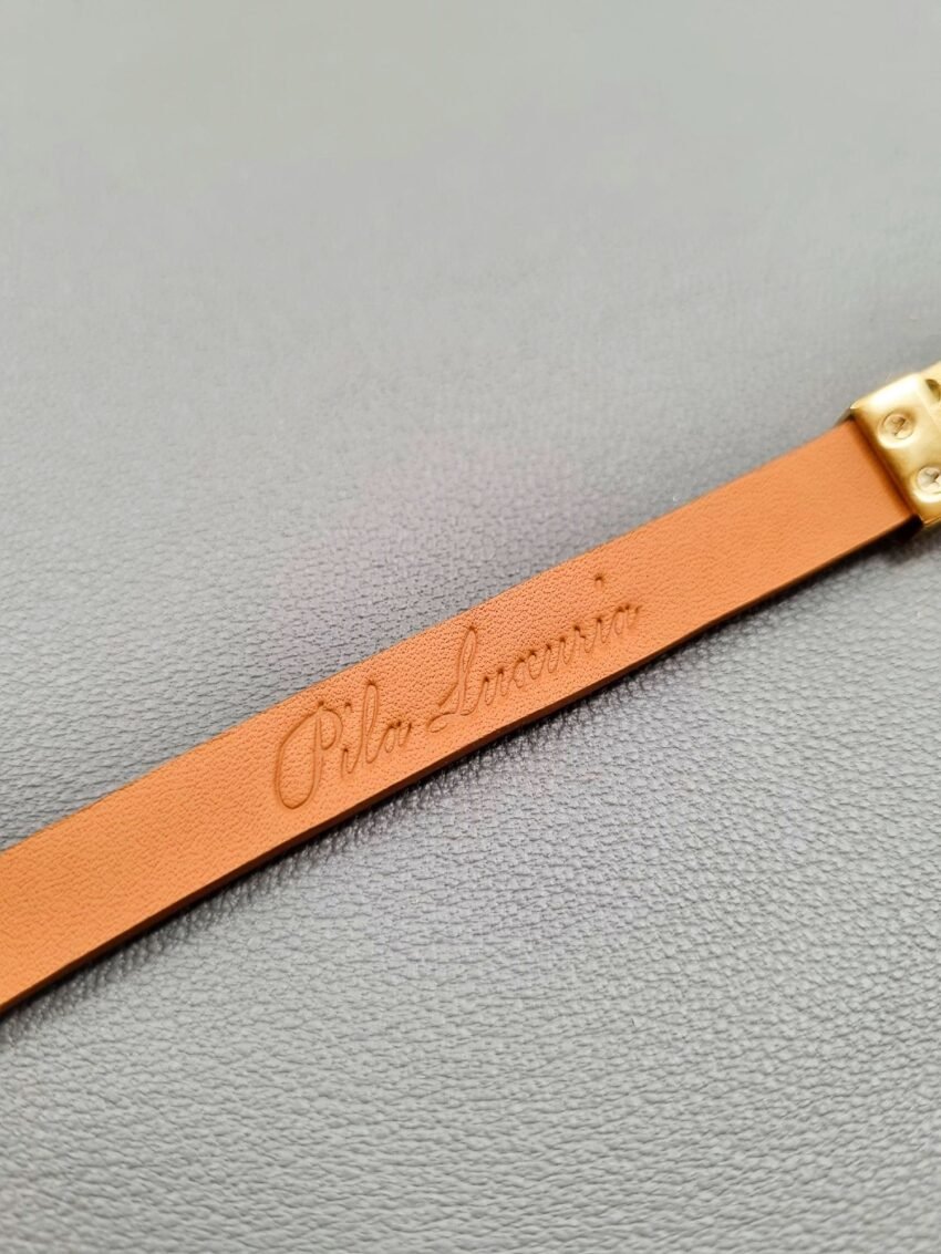 Embossed logo of a luxury green shark leather bracelet with a magnetic clasp, made by Pila Luxuria in Canada.