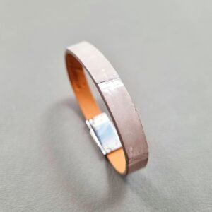 Angled view of a luxury grey crocodile bracelet with a magnetic clasp, made by Pila Luxuria in Canada.