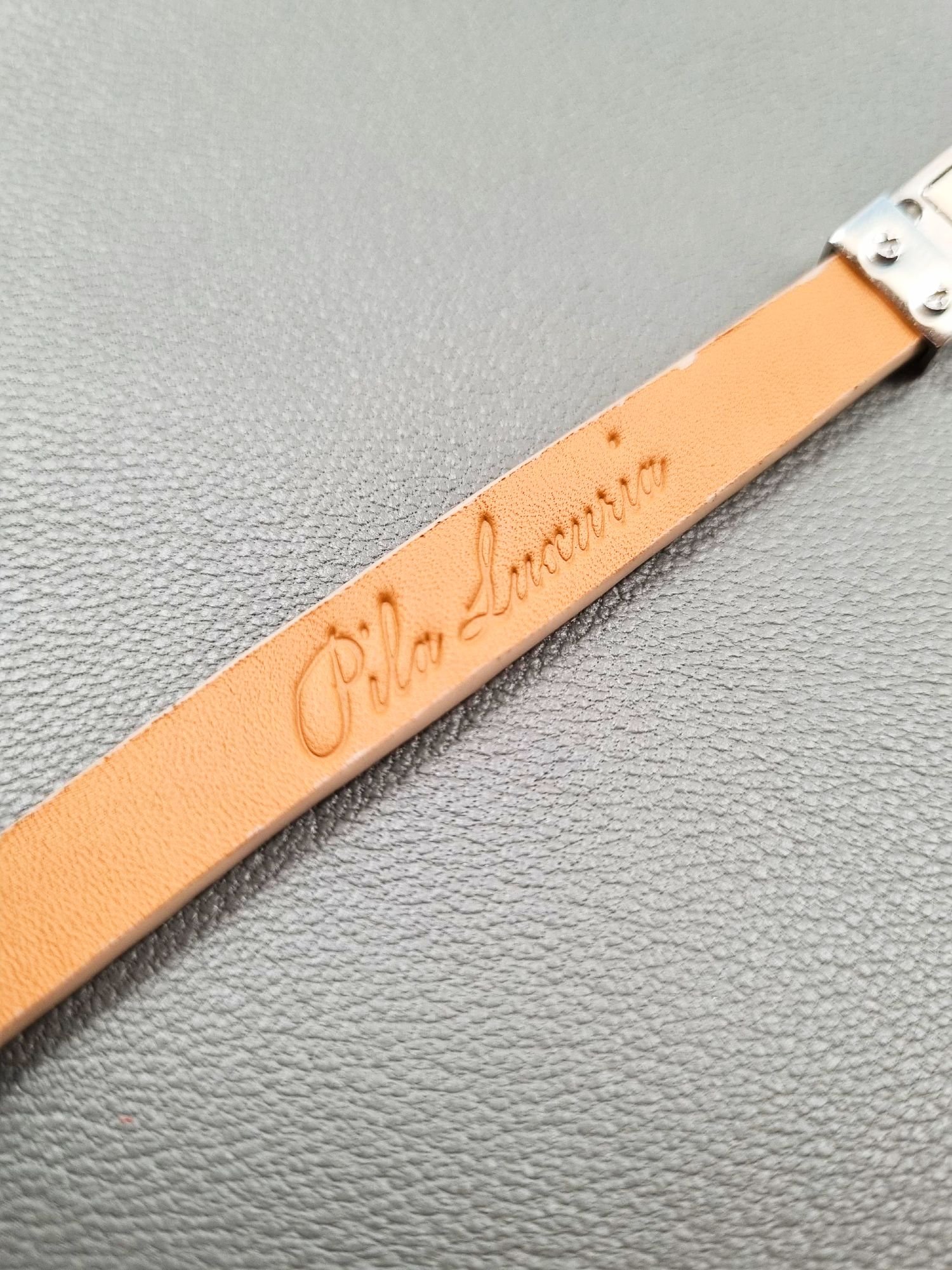 Logo of a luxury himalayan crocodile bracelet with a magnetic clasp, made by Pila Luxuria in Canada.