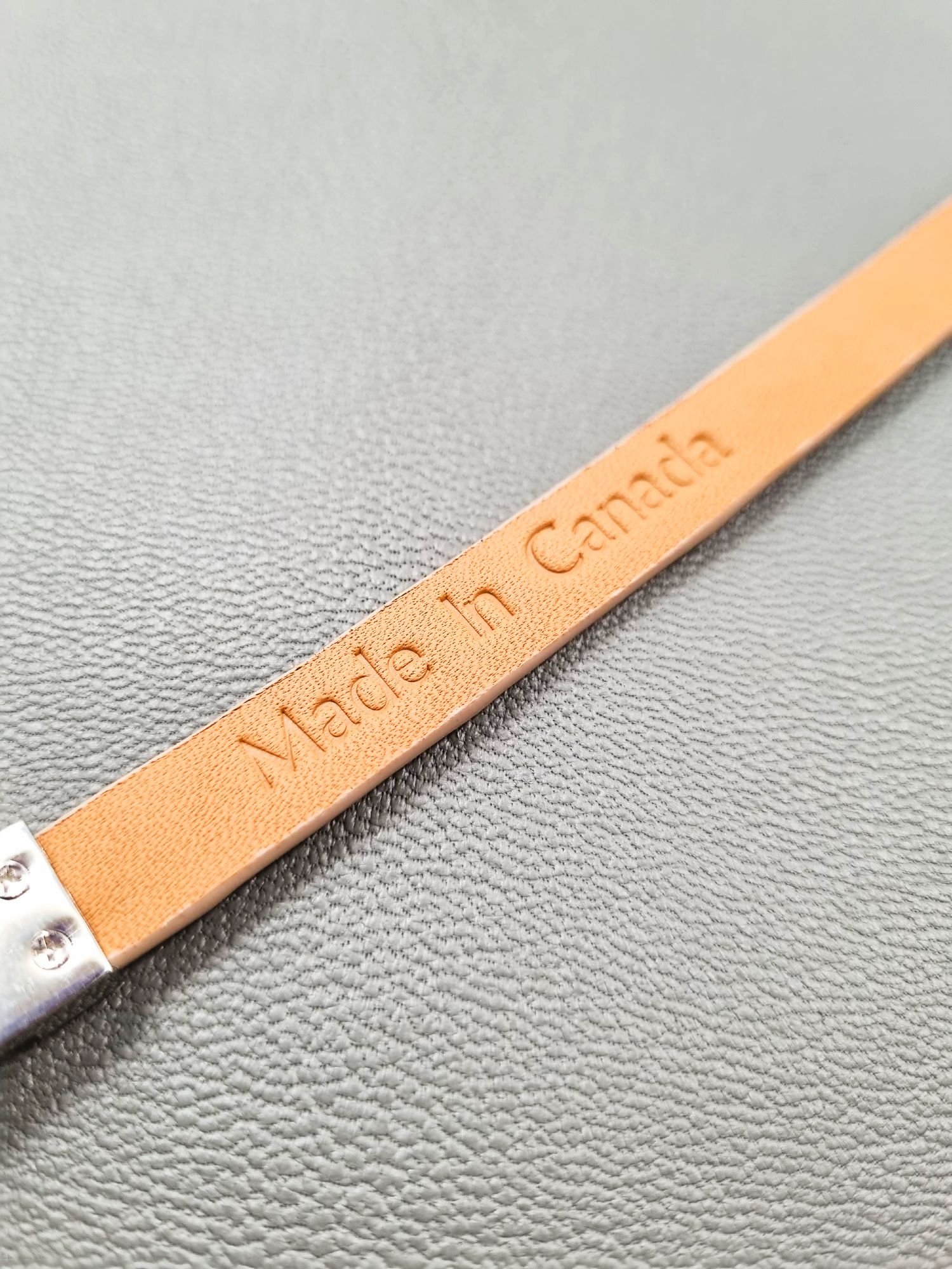 Embosed Made in Canada logo on a luxury himalayan crocodile bracelet with a magnetic clasp, made by Pila Luxuria in Canada.