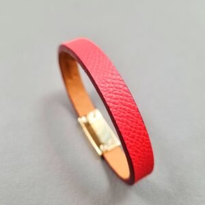 Angled view of a luxury red epsom leather bracelet with a magnetic clasp, made by Pila Luxuria in Canada.