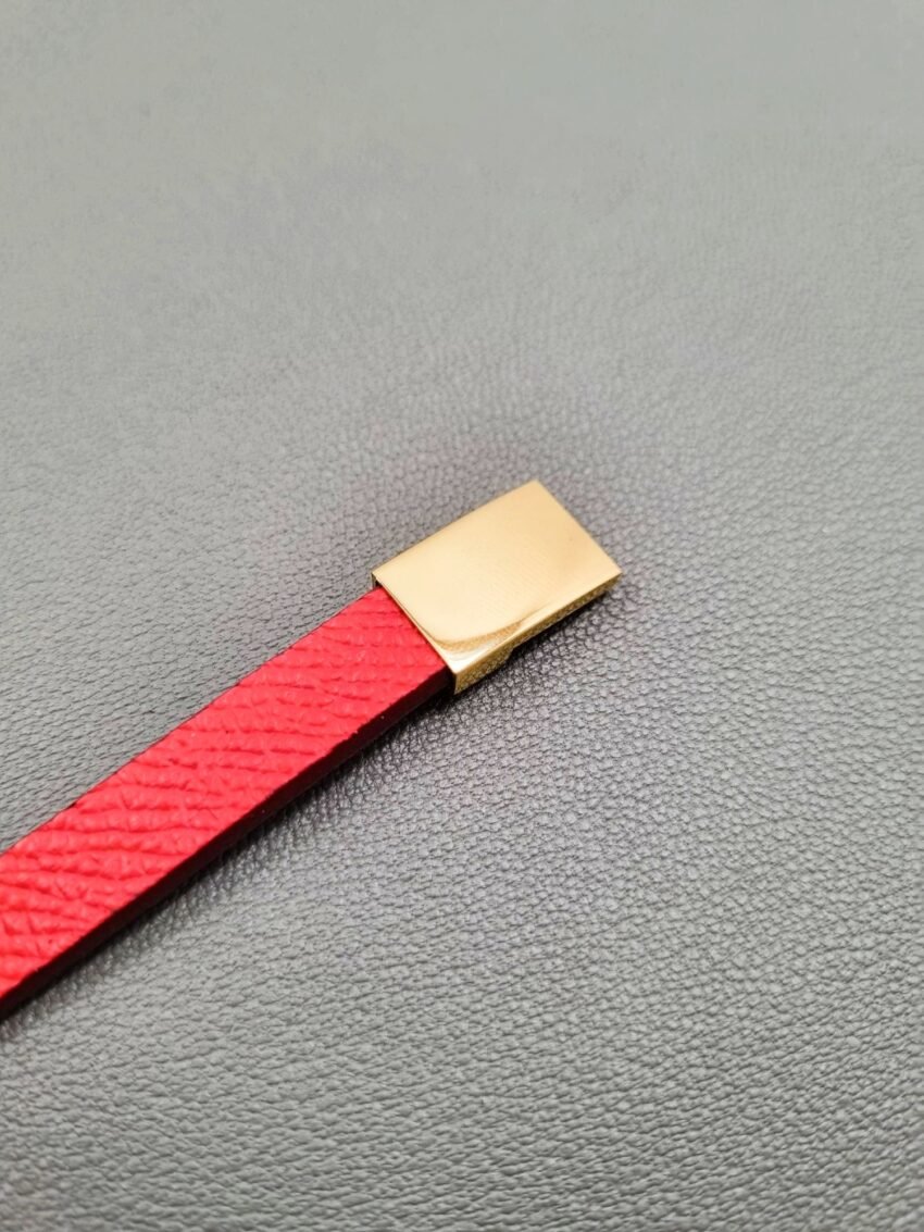 Red epi leather bracelet with a gold magnetic clasp, made by Pila Luxuria in Canada.
