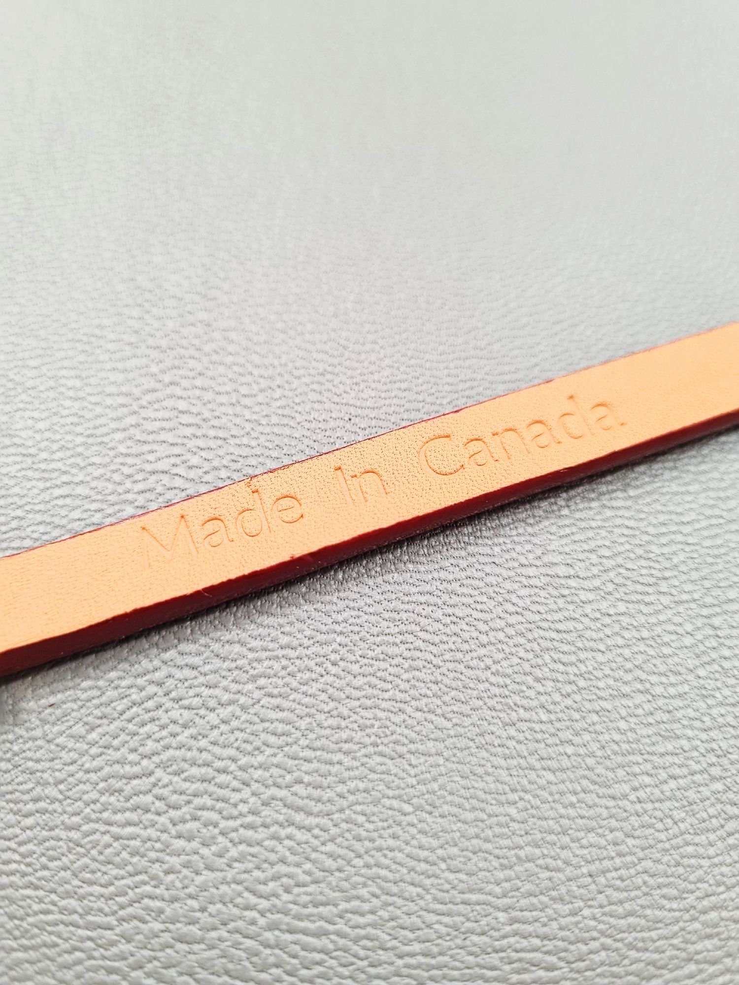 Made In Canada logo of a luxury red epsom leather bracelet with a magnetic clasp, made by Pila Luxuria in Canada.