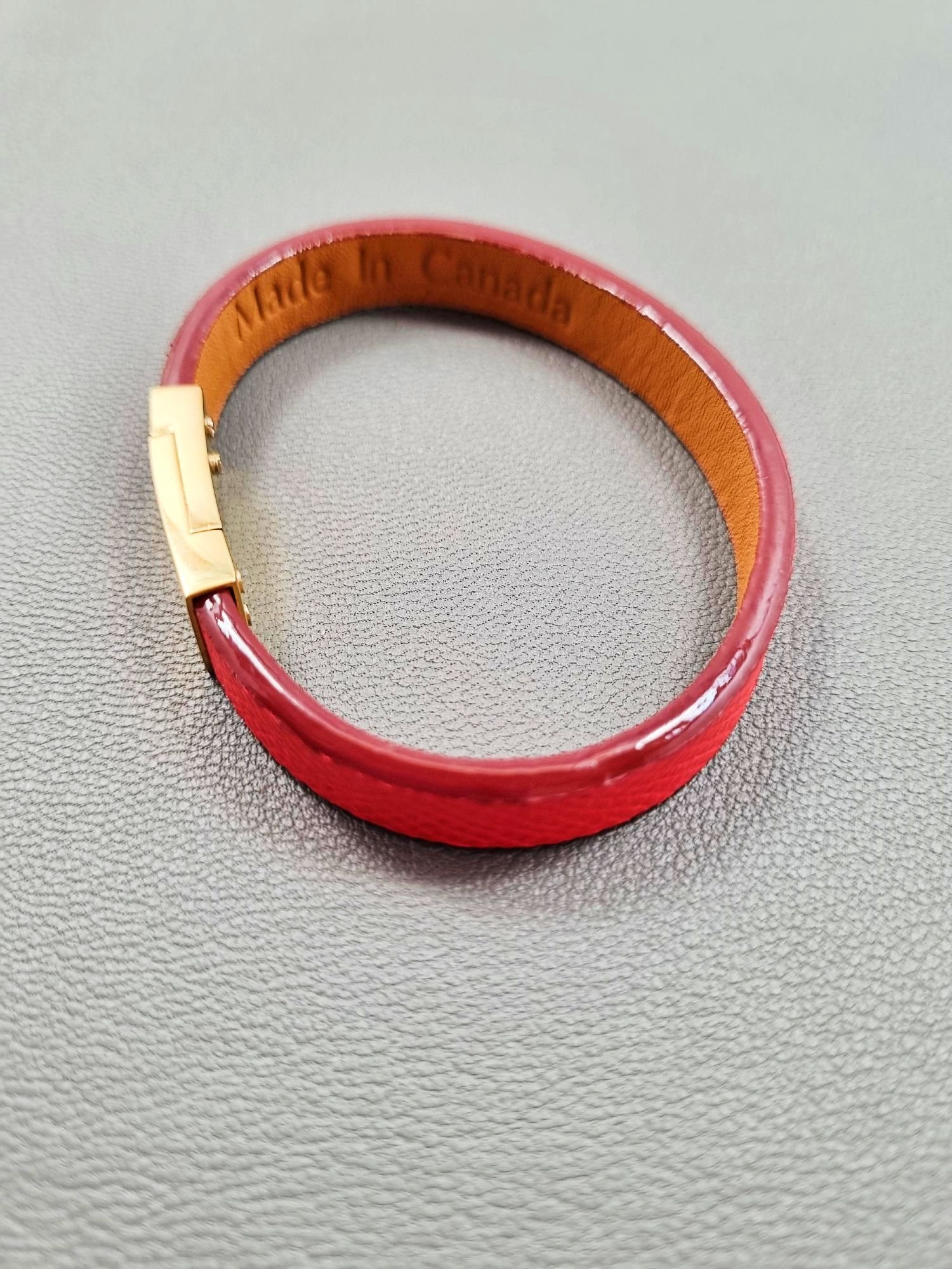 Top view of a luxury red epsom leather bracelet with a magnetic clasp, made by Pila Luxuria in Canada.