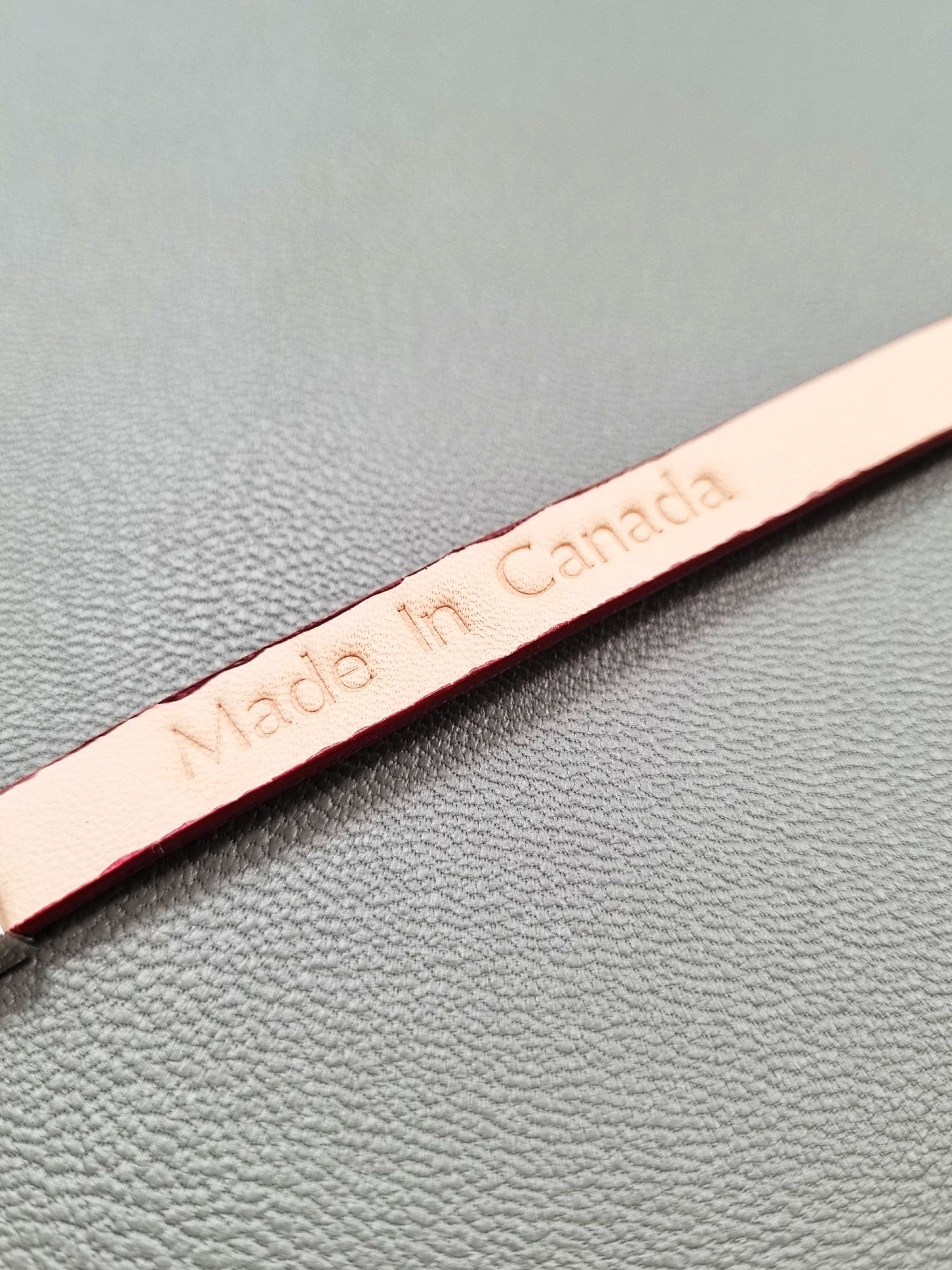 Made In Canada logo of a luxury red goatskin leather bracelet with a magnetic clasp, made by Pila Luxuria in Canada.