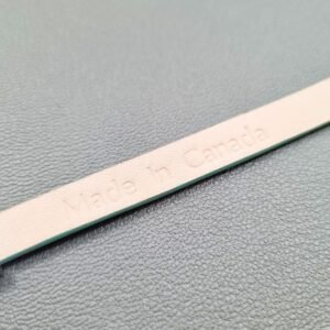 Embossed logo of a luxury tiffany saffiano leather bracelet with a magnetic clasp, made by Pila Luxuria in Canada.