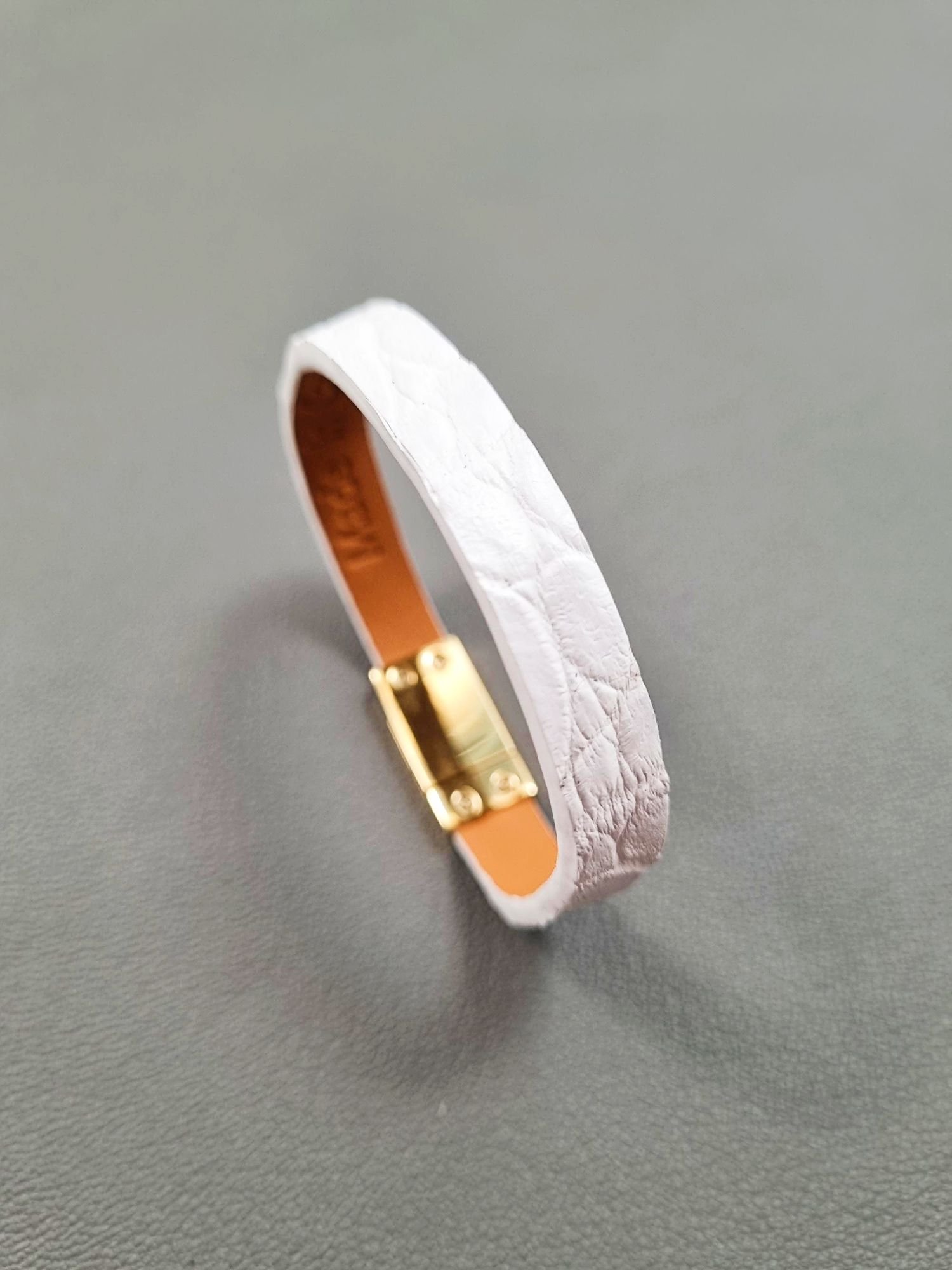 Angled view of a luxury white crocodile leather bracelet with a magnetic clasp, made by Pila Luxuria in Canada.