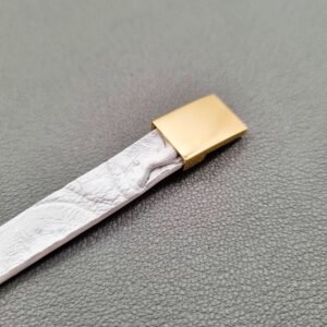 White crocodile lleather bracelet with a gold magnetic clasp, made by Pila Luxuria in Canada.