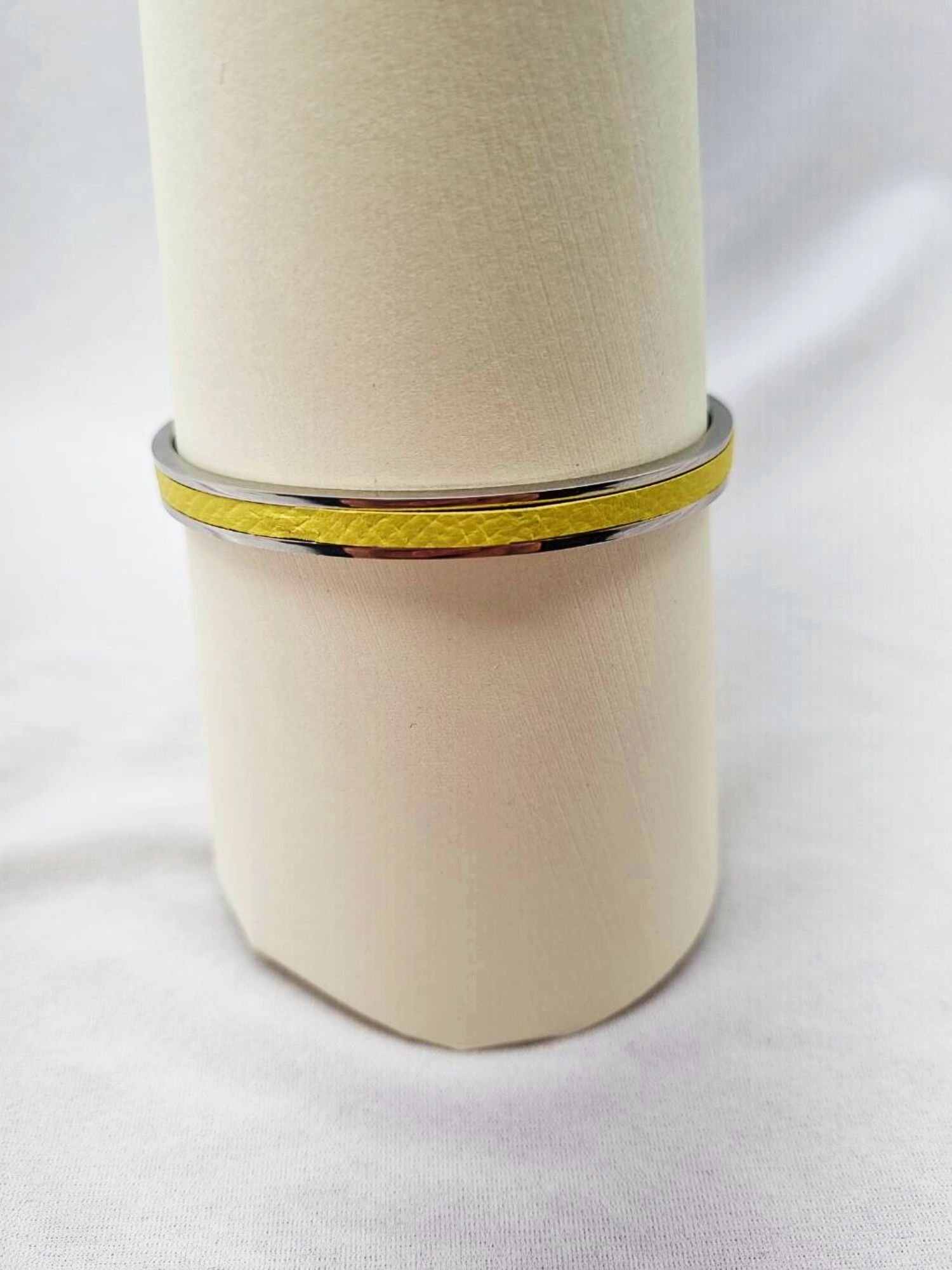 Stainless steel bracelet with yellow epsom leather inlay.